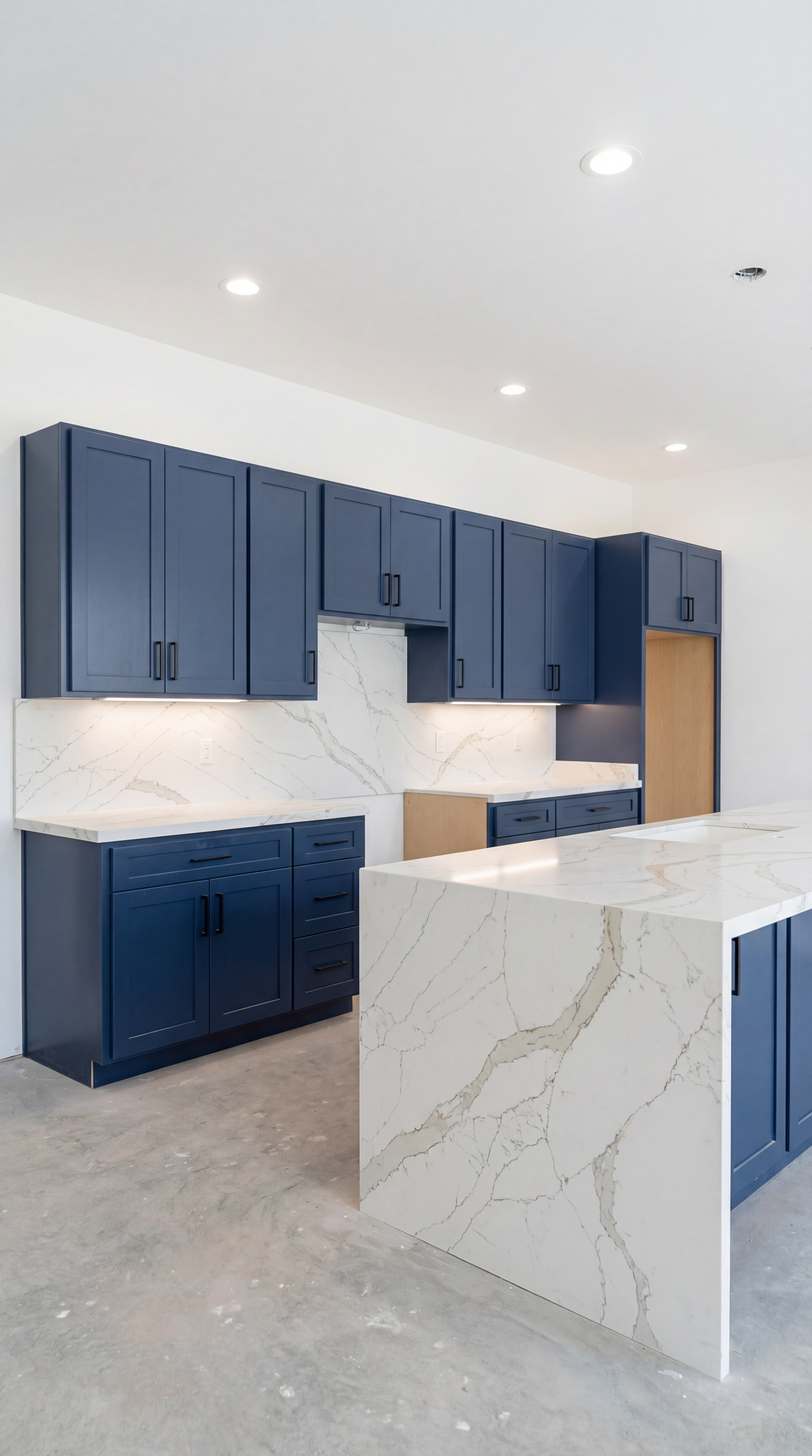 Navy blue kitchen with quartz countertops